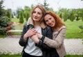 Two happy affectionate women friends hugging