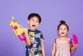 Two Happy Asian little boy and girl holding plastic water gun Royalty Free Stock Photo