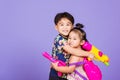 Two Happy Asian little boy and girl holding plastic water gun Royalty Free Stock Photo