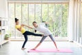 Two happy asian women in yoga poses in yoga studio with natural light setting scene / exercise concept / yoga practice / copy