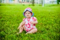 Two happy baby boy and a girl age 9 months old, sitting on the grass and interact, talk, look at each other. Royalty Free Stock Photo