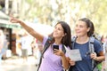 Two backpackers sightseeing pointing at landmark