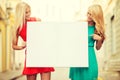 Two happy blonde women with blank white board Royalty Free Stock Photo