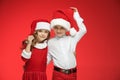 Two happy boy and girl in santa claus hats with gift boxes at studio Royalty Free Stock Photo