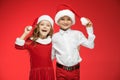 Two happy boy and girl in santa claus hats with gift boxes at studio Royalty Free Stock Photo