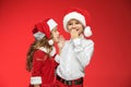 Two happy boy and girl in santa claus hats with gift boxes at studio Royalty Free Stock Photo