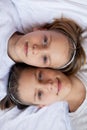 Two happy boys,brothers who are smiling together. twins und best friends. lie near each other, hug teenagers Royalty Free Stock Photo