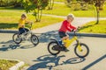 Two happy boys cycling in the park