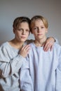 Two happy boys,brothers who are smiling together. twins und best friends. stay near each other, hug teenagers Royalty Free Stock Photo