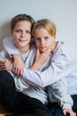 Two happy boys,brothers who are smiling together. twins und best friends. sit near each other, hug teenagers Royalty Free Stock Photo