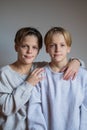 Two happy boys,brothers who are smiling together. twins und best friends. stay near each other, hug teenagers Royalty Free Stock Photo