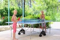 Two happy boys playing ping pong outdoors Royalty Free Stock Photo