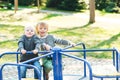 Two happy boys playing on playground in a park. Royalty Free Stock Photo