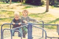 Two happy boys playing on playground in a park. Toned. Royalty Free Stock Photo