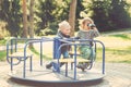 Two happy boys playing on playground in a park. Toned. Royalty Free Stock Photo