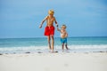 Two happy boys run on the sand beach holding hands Royalty Free Stock Photo