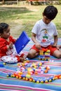 Two happy boys in society park, happy Asian brothers who are smiling happily together. Brothers play outdoors in summer, best Royalty Free Stock Photo