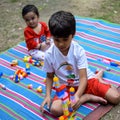 Two happy boys in society park, happy Asian brothers who are smiling happily together. Brothers play outdoors in summer, best Royalty Free Stock Photo