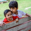 Two happy boys in society park, happy Asian brothers who are smiling happily together. Brothers play outdoors in summer, best Royalty Free Stock Photo