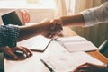 Two happy businessman shaking hands over the desk Royalty Free Stock Photo