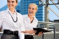 Two happy businesswomen with folders Royalty Free Stock Photo