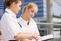 Two happy businesswomen with paper chart