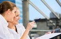 Two happy businesswomen with paper chart