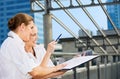 Two happy businesswomen with paper chart Royalty Free Stock Photo