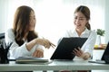 Two happy businesswomen working together on new project at bright modern office Royalty Free Stock Photo