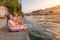 Happy caucasian and asian girls friends meeting great sunset on a river Saone in Lyon city. Travel and lifestyle in France Royalty Free Stock Photo