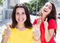Two happy caucasian girls showing thumbs up Royalty Free Stock Photo