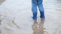 Two happy child playing in puddle after the rain