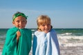 Two happy children on beach, sea in background. Royalty Free Stock Photo