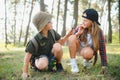 Two happy children having fun during forest hike on beautiful day in pine forest. Cute boy scout with binoculars during Royalty Free Stock Photo