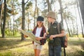 Two happy children having fun during forest hike on beautiful day in pine forest. Cute boy scout with binoculars during Royalty Free Stock Photo