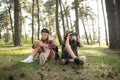 Two happy children having fun during forest hike on beautiful day in pine forest. Cute boy scout with binoculars during Royalty Free Stock Photo