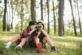 Two happy children having fun during forest hike on beautiful day in pine forest. Cute boy scout with binoculars during Royalty Free Stock Photo