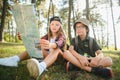 Two happy children having fun during forest hike on beautiful day in pine forest. Cute boy scout with binoculars during Royalty Free Stock Photo