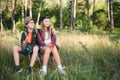 Two happy children having fun during forest hike on beautiful day in pine forest. Cute boy scout with binoculars during Royalty Free Stock Photo