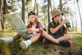 Two happy children having fun during forest hike on beautiful day in pine forest. Cute boy scout with binoculars during Royalty Free Stock Photo