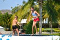 Kids fun jumping on trampoline. Children jump into water. Happy summer time in Park. Girl and boy in bathing suits in water Park.