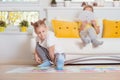 Two happy children playing exciting game at home