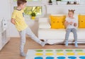 Two happy children playing exciting game at home Royalty Free Stock Photo