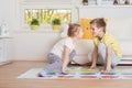 Two happy children playing exciting game at home