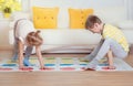 Two happy children playing exciting game at home Royalty Free Stock Photo