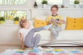 Two happy children playing exciting game at home Royalty Free Stock Photo