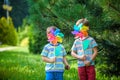 Two happy children playing in garden with windmill pinwheel. Ado Royalty Free Stock Photo