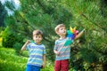 Two happy children playing in garden with windmill pinwheel. Adorable sibling brothers are best friends. Cute kid boy smile spring Royalty Free Stock Photo