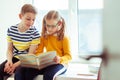 Two happy children reading funny book at holidays Royalty Free Stock Photo