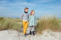 Two happy cute teenager brother and siater staing on beach with white sand on Baltic sea Royalty Free Stock Photo